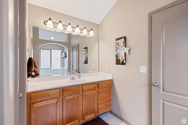 5701 W Emmeline Dr, Herriman, UT 84096 - bathroom with lofted ceiling, tile patterned floors, and vanity