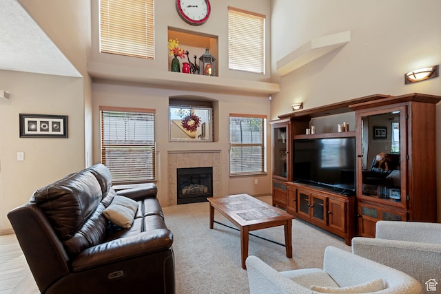 5701 W Emmeline Dr, Herriman, UT 84096 - living room featuring a fireplace, a high ceiling, and light carpet