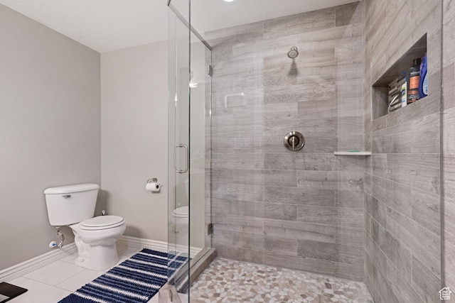 5701 W Emmeline Dr, Herriman, UT 84096 - bathroom with a shower stall, toilet, tile patterned floors, and baseboards
