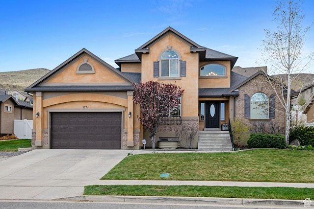5701 W Emmeline Dr, Herriman, UT 84096 - traditional home with stucco siding, driveway, a garage, and a front yard