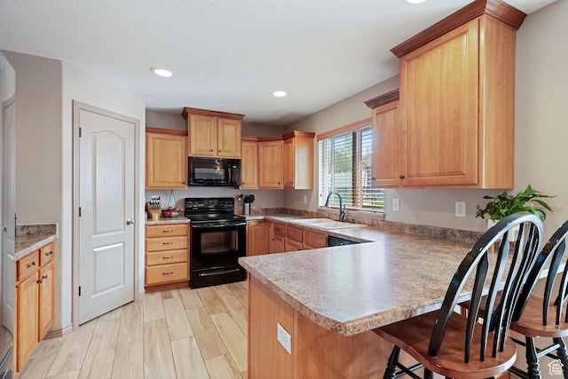 5701 W Emmeline Dr, Herriman, UT 84096 - kitchen featuring a kitchen breakfast bar, light countertops, a sink, black appliances, and a peninsula