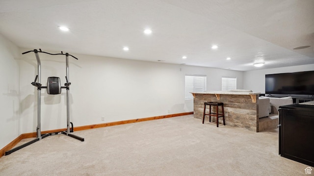 workout area with light carpet, baseboards, and recessed lighting