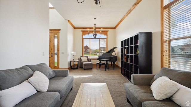 living room with baseboards, carpet floors, a notable chandelier, and ornamental molding