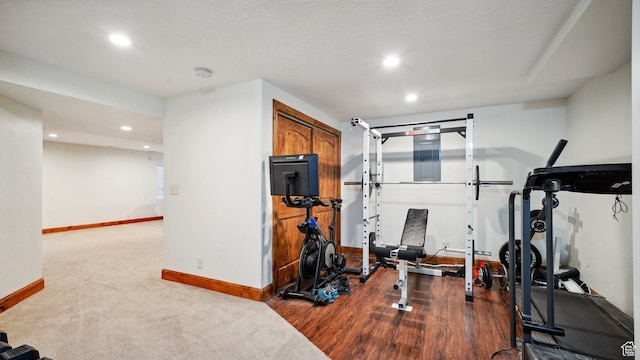 workout room with dark carpet, baseboards, and recessed lighting