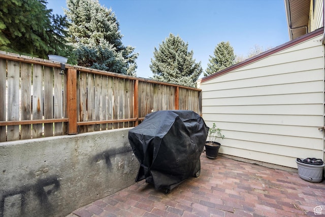 view of patio / terrace with a grill and fence