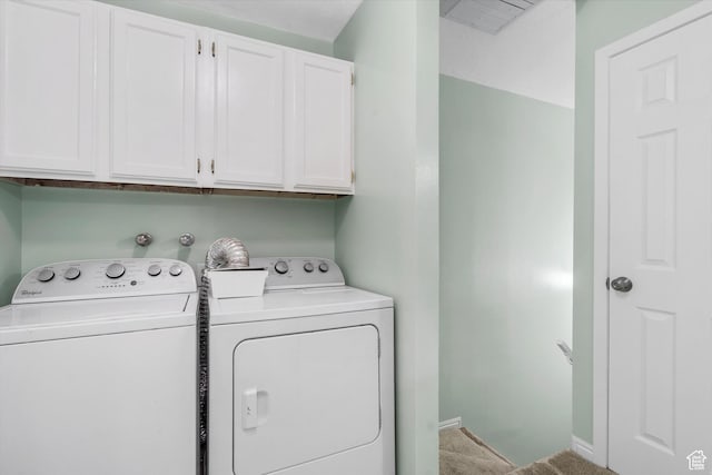 clothes washing area with baseboards, carpet flooring, washer and dryer, and cabinet space
