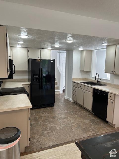 2590 W Central Pk Cir, Taylorsville, UT 84129 - kitchen with black appliances, light countertops, and stone tile floors