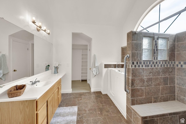 2590 W Central Pk Cir, Taylorsville, UT 84129 - bathroom with a bath, vanity, a tile shower, stone finish flooring, and lofted ceiling
