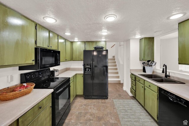 2590 W Central Pk Cir, Taylorsville, UT 84129 - kitchen with black appliances, green cabinets, light countertops, and a textured ceiling