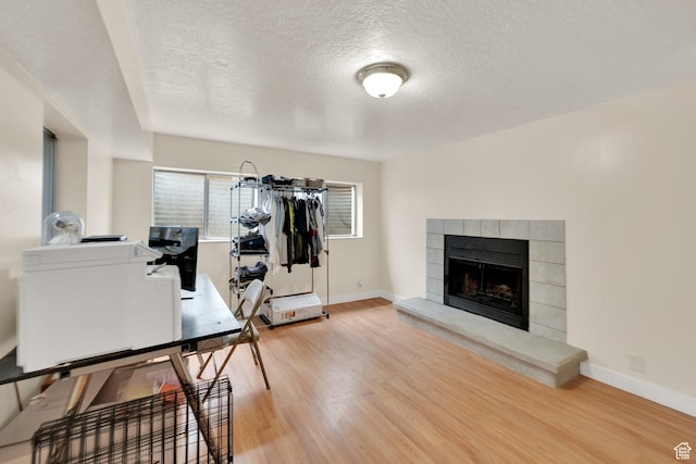 2590 W Central Pk Cir, Taylorsville, UT 84129 - office space with a textured ceiling, wood finished floors, and a tiled fireplace