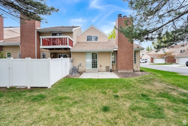 2590 W Central Pk Cir, Taylorsville, UT 84129 - rear view of house featuring a chimney, a patio area, and roof with shingles