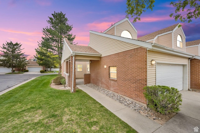 view of front of property featuring concrete driveway, brick siding, a garage, and a front yard