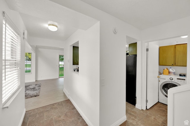 2590 W Central Pk Cir, Taylorsville, UT 84129 - corridor featuring washer / dryer and light stone finish floors