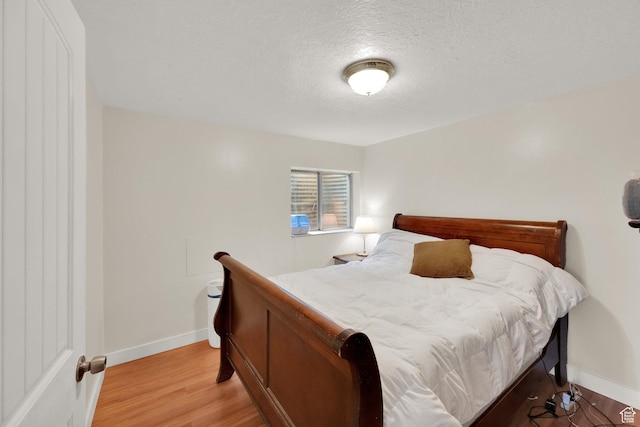 2590 W Central Pk Cir, Taylorsville, UT 84129 - bedroom with light wood-style floors and a textured ceiling