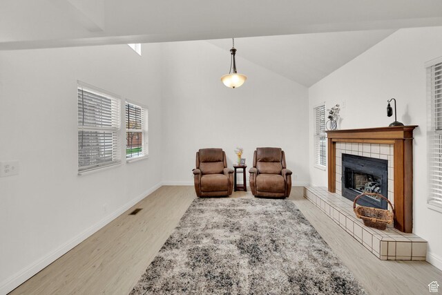 2590 W Central Pk Cir, Taylorsville, UT 84129 - living area with wood finished floors, a fireplace, and high vaulted ceiling