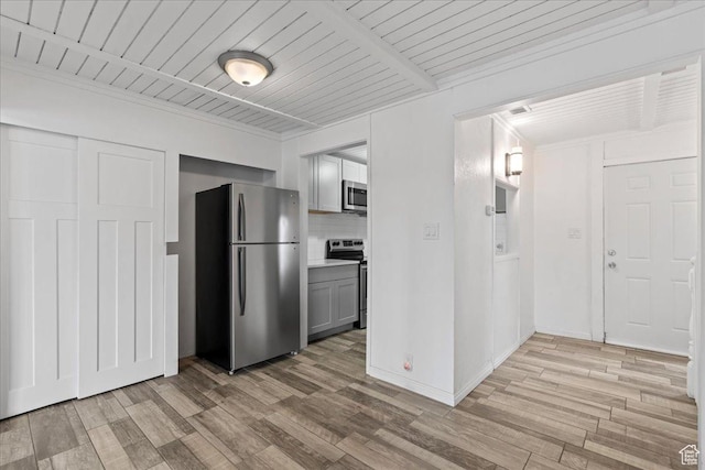 4216 S Solitude Rdg Unit A, Taylorsville, UT 84129 - kitchen featuring light countertops, light wood-type flooring, decorative backsplash, gray cabinetry, and appliances with stainless steel finishes