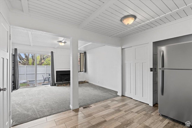 4216 S Solitude Rdg Unit A, Taylorsville, UT 84129 - unfurnished living room featuring beamed ceiling, light wood-style flooring, visible vents, and baseboards