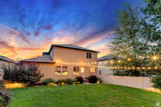11113 S Cadbury Dr, South Jordan, UT 84095 - back of property with stucco siding, fence, and a lawn