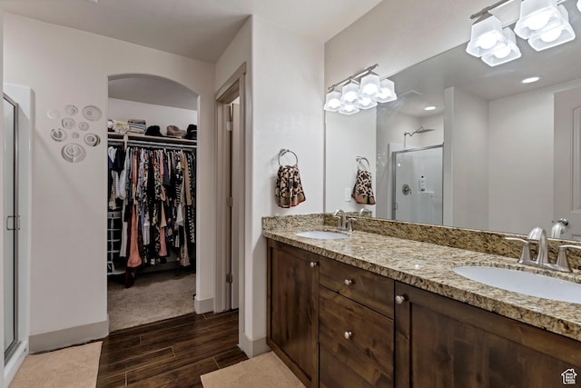 11113 S Cadbury Dr, South Jordan, UT 84095 - full bath featuring double vanity, a shower stall, wood finished floors, and a sink