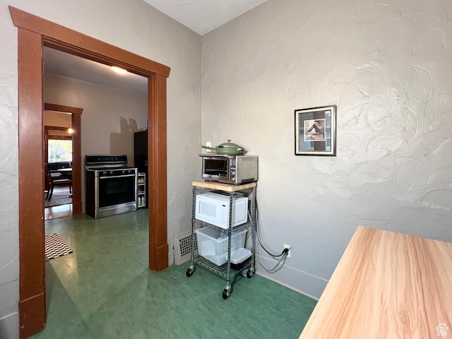 hallway featuring baseboards, visible vents, and a toaster