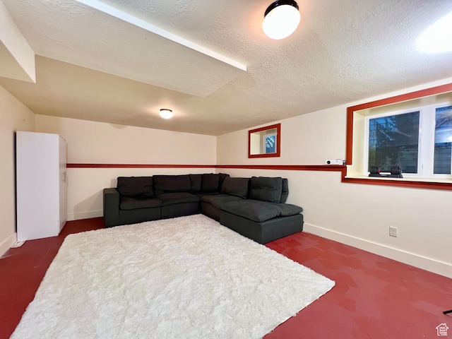 living room with dark carpet, baseboards, and a textured ceiling
