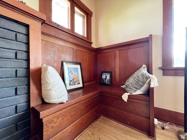interior space with wainscoting and wood finished floors