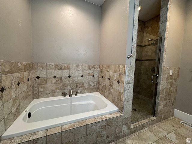 bathroom featuring a garden tub and a stall shower