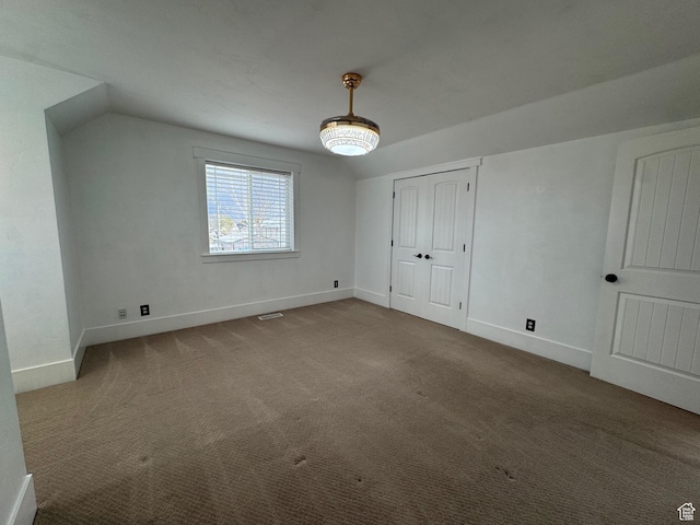 interior space featuring baseboards and carpet