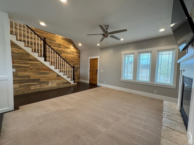 unfurnished living room featuring recessed lighting, a ceiling fan, baseboards, lofted ceiling, and stairway