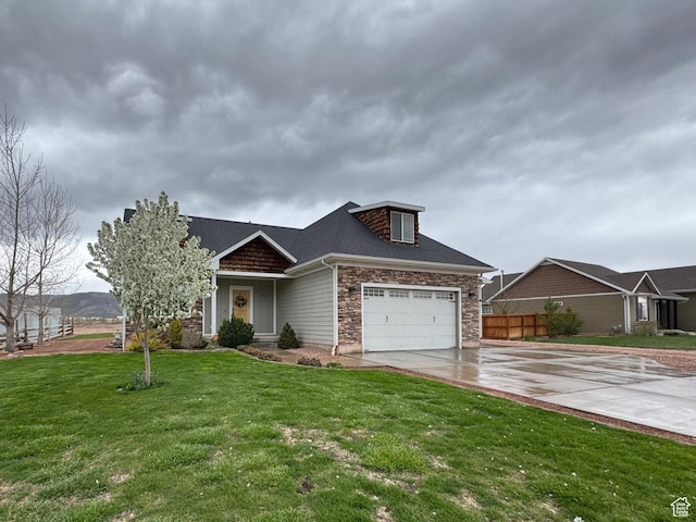 view of front of house featuring fence, stone siding, a garage, a front yard, and concrete driveway