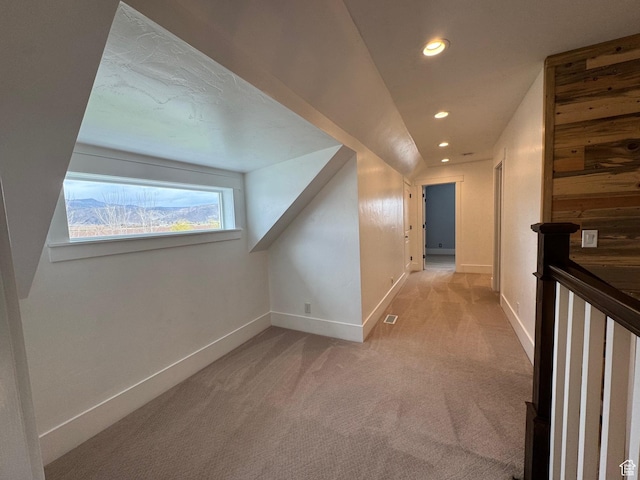 hallway featuring baseboards, recessed lighting, an upstairs landing, and light colored carpet