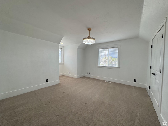 bonus room with baseboards, plenty of natural light, and lofted ceiling