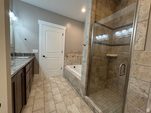 full bathroom featuring vanity, a stall shower, and a bath