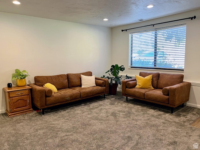 carpeted living area featuring baseboards, visible vents, and recessed lighting