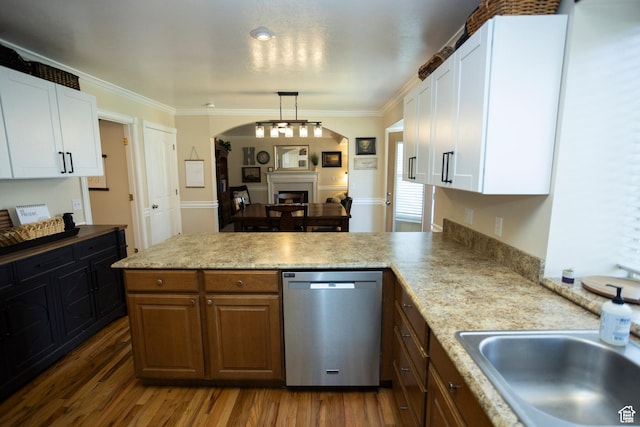 7532 N Castle Rock Rd E, Eagle Mountain, UT 84005 - kitchen with arched walkways, a peninsula, stainless steel dishwasher, and white cabinetry