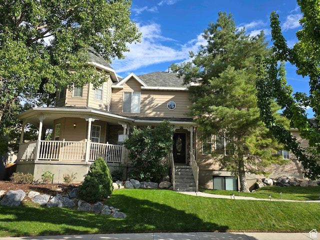farmhouse-style home featuring a porch and a front lawn