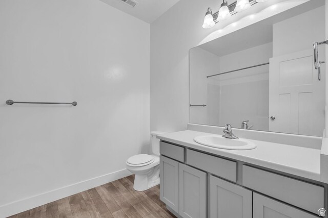84 W Silver Springs Dr, Vineyard, UT 84059 - full bath with wood finished floors, visible vents, toilet, vanity, and baseboards