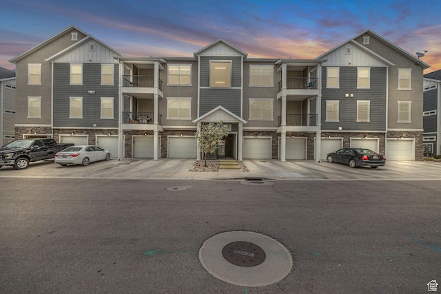 84 W Silver Springs Dr, Vineyard, UT 84059 - multi unit property featuring stone siding, an attached garage, driveway, and board and batten siding