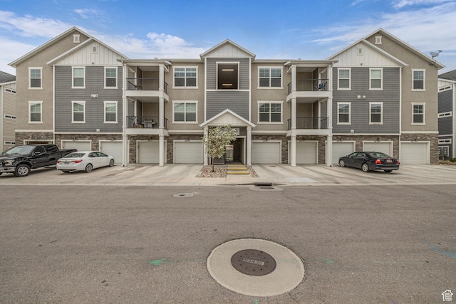84 W Silver Springs Dr, Vineyard, UT 84059 - view of property with stone siding, board and batten siding, and a garage