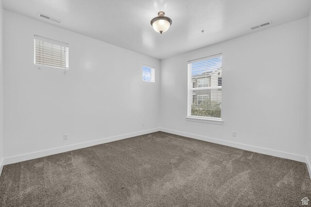 84 W Silver Springs Dr, Vineyard, UT 84059 - unfurnished room featuring dark carpet, visible vents, and baseboards