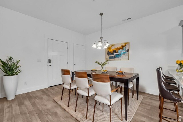 84 W Silver Springs Dr, Vineyard, UT 84059 - dining space featuring baseboards, a notable chandelier, light wood-style floors, and visible vents