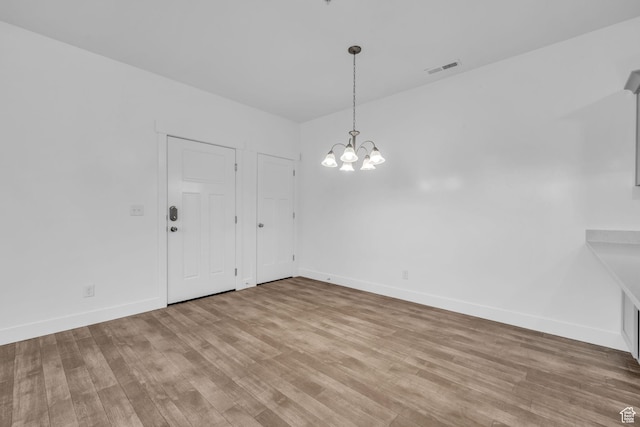 84 W Silver Springs Dr, Vineyard, UT 84059 - unfurnished dining area with visible vents, baseboards, wood finished floors, and an inviting chandelier
