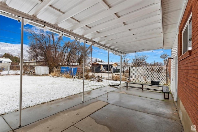snow covered patio with fence