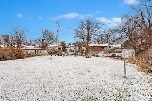 yard covered in snow featuring fence