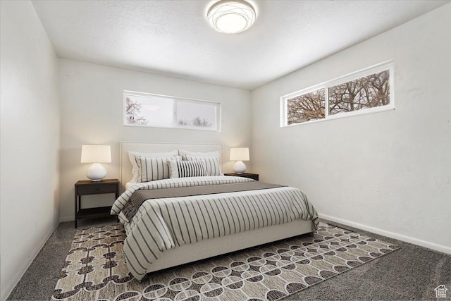 carpeted bedroom featuring baseboards