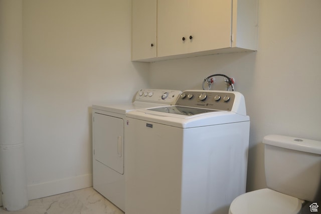 laundry room featuring marble finish floor, washing machine and clothes dryer, and laundry area