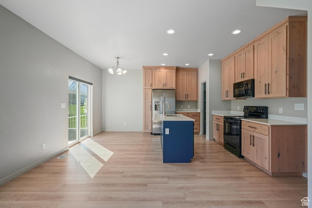 kitchen featuring recessed lighting, light wood-style floors, a chandelier, light countertops, and black appliances