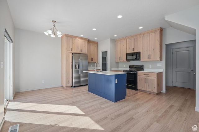 kitchen featuring light wood-type flooring, visible vents, light brown cabinets, light countertops, and black appliances