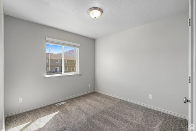 carpeted empty room with baseboards and visible vents