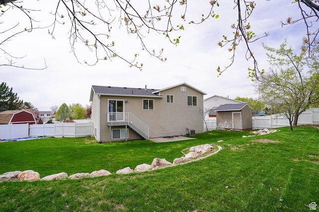 back of property with a shed, an outbuilding, and stairway
